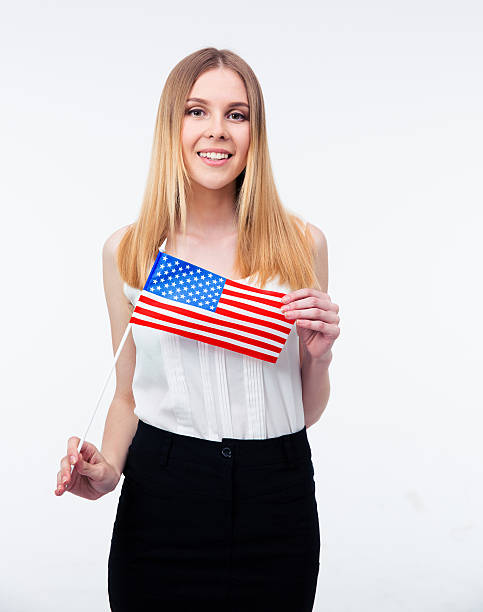 istock Smiling young businesswoman holding US flag 475846232