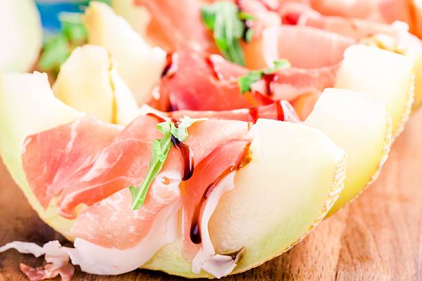 istock melon with thin slices of prosciutto and arugula leaves 475846562