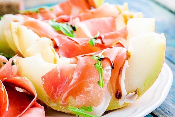 istock melon with slices of prosciutto, arugula and balsamic sauce closeup 475846566