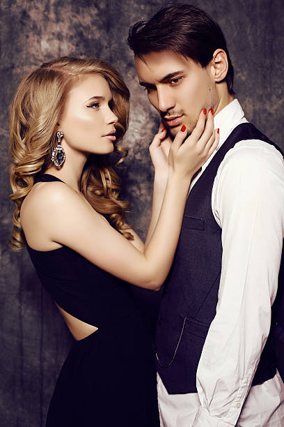 istock beautiful sensual couple in elegant clothes posing in studio 475846930