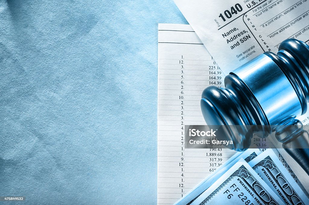 Budget, tax form, gavel and dollars Annual budget, tax form, gavel and dollars 2015 Stock Photo