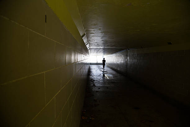 istock Female running in through a tunnel 475850128