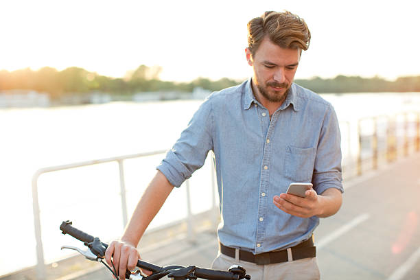 istock Young man enjoying sunset by the river. 475850304