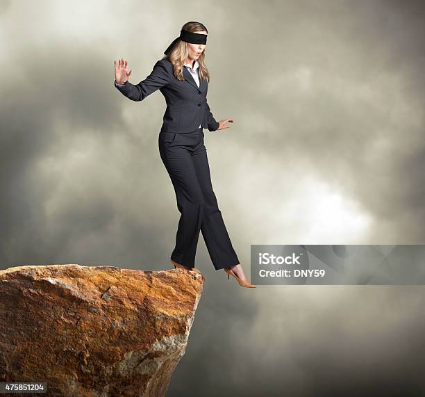 Blindfolded Businesswoman About To Step Off Of A Clif Stock Photo - Download Image Now