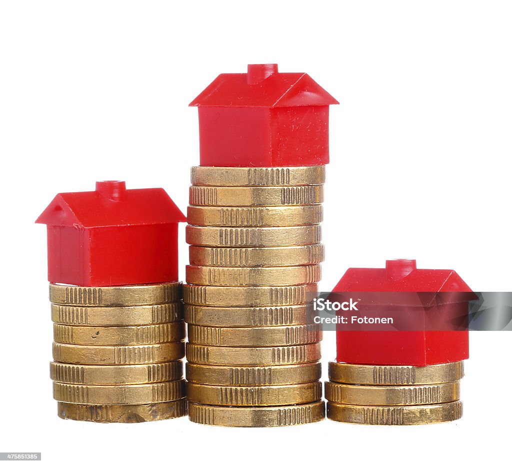 House prices Red small house on top of stacks of coins isolated on white background. Building Exterior Stock Photo