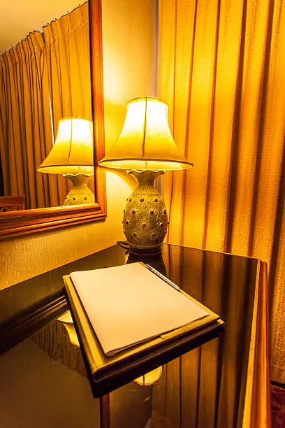 notebook on the table with lamp in retro style