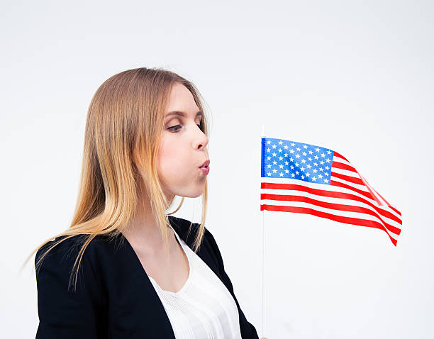 istock Businesswoman blowing on US flag 475856586