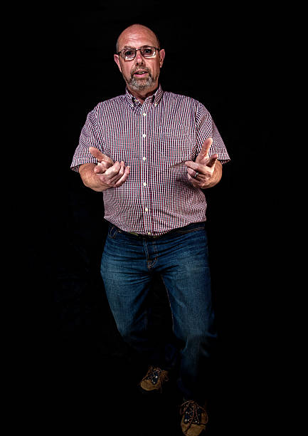 istock Mature man with beard and glasses pointing hands portrait 475856614