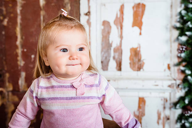 Cute blond little girl with grey eyes and plump cheeks