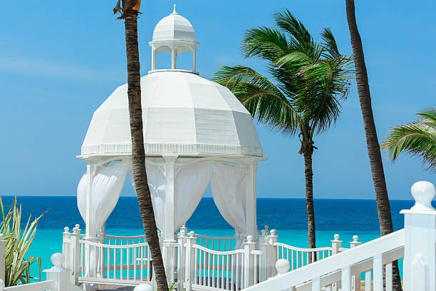 istock Beautiful cozy inviting  white gazebo standing against azure turquoise ocean 475856896