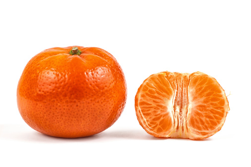 half peeled tangerine and an unpeeled mandarine orange