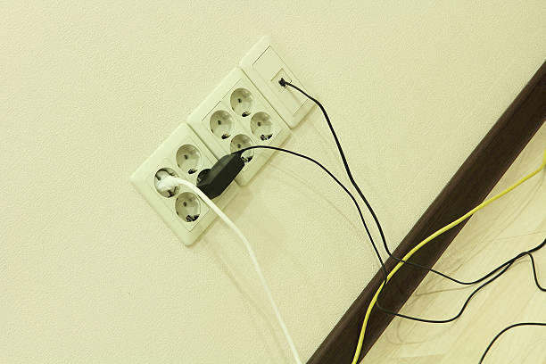 istock Electric sockets on home wall with cables. 475860532