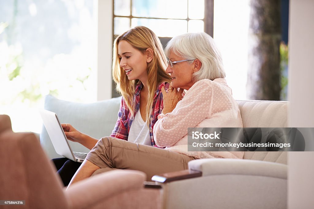 Adult Granddaughter Helping Grandmother With Computer Grandmother Stock Photo