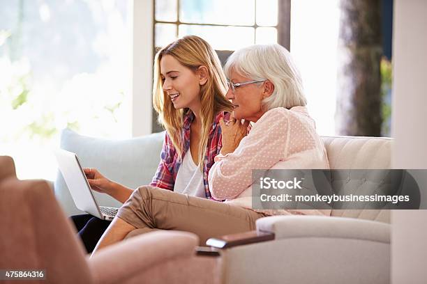 Adult Granddaughter Helping Grandmother With Computer Stock Photo - Download Image Now