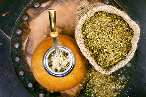 Yerba mate in a traditional gourd and dry herb