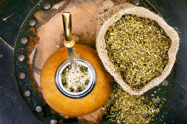 Yerba mate in a traditional calabash gourd and bag of dry herb