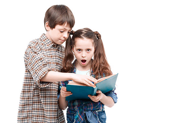 istock Brother and sister posing with a book 475869344
