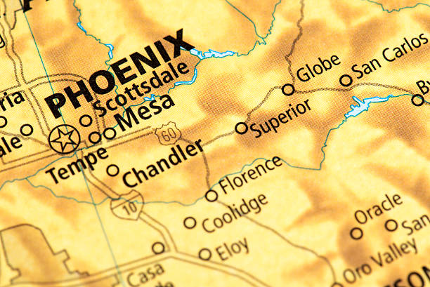 A close-up photograph of a printed road map centered on the metropolitan area of Tucson, Arizona. The image clearly shows major interstates, including I-10, and highlights key surrounding areas such as Marana, Oro Valley, Casas Adobes, Sahuarita, and Green Valley. Prominently featured are the distinctive green areas representing the Saguaro National Park (both east and west units) and other natural landmarks like the Coronado National Forest and the Catalina area. This visual emphasizes travel, geography, and the unique desert landscape of Southern Arizona.
