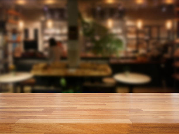 istock mpty wooden table and blurred cafe background 475870442