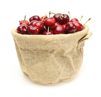 Pictured cherries in a jute bag.