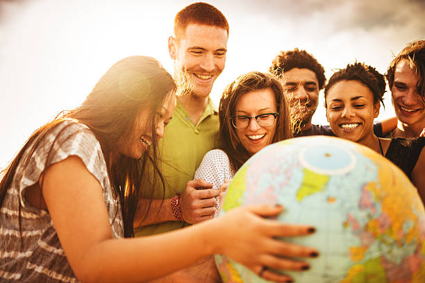 teenagers college student smiling with globe teenagers college student smiling with globe multi ethnic group college student group of people global communications stock pictures, royalty-free photos & images