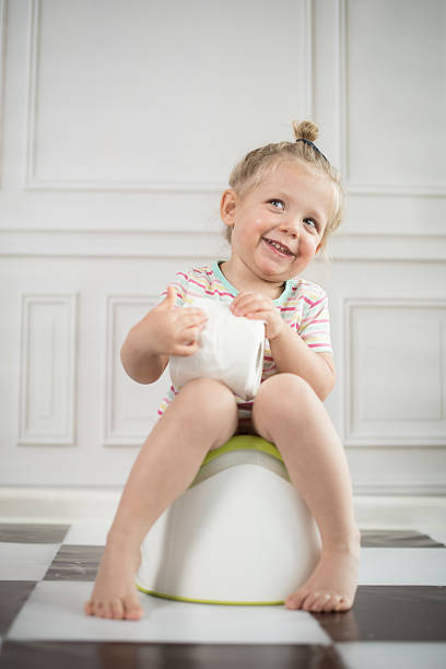 Little girl on potty stock photo