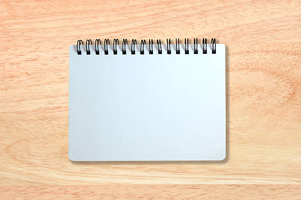 istock white page of notebook on wood texture 475874614