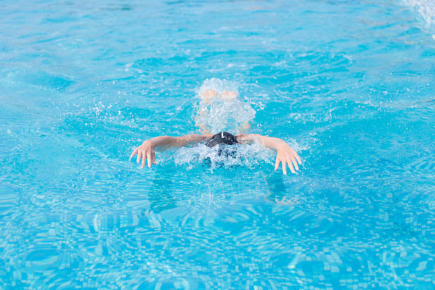 istock Young girl swimming butterfly stroke style 475874940