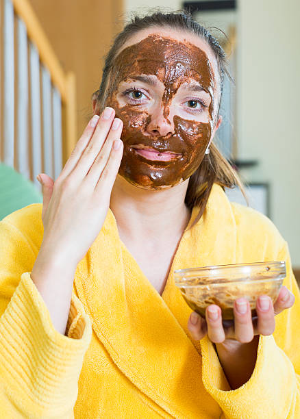 istock woman  putting cosmetic on face 475875232