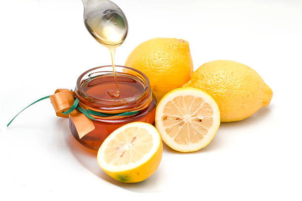 Fresh honey and lemons stock photo