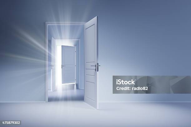 Open White Doors With Rays Of Light On Blue Wall Stock Photo - Download Image Now - Door, Open Sign, Open