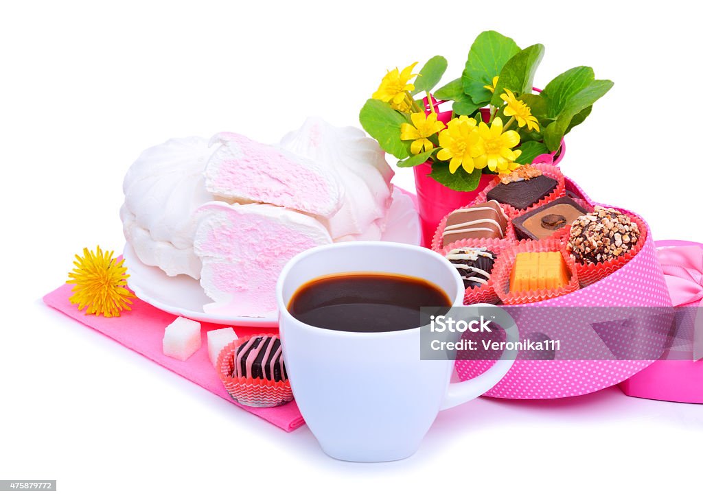 Cup of coffee with murshmellow, chocolate sweets, yellow wildflowers 2015 Stock Photo