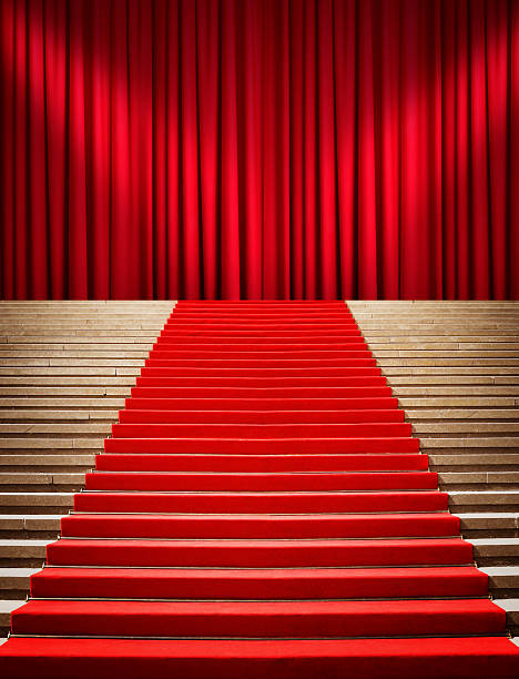 istock Staircase with red carpet and curtain with spotlights 475880042