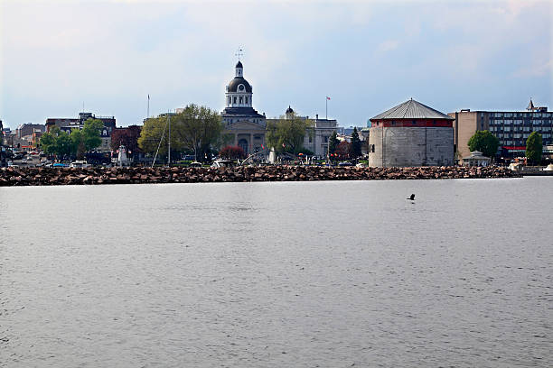 Skyline Downtown Kingston in the cloudy afternoon of Victoria Day KINGSTON, ONTARIO/CANADA ? MAY 18 2015: Skyline Downtown Kingston in very later cloudy afternoon ready for celebration of Victoria Day view from level of Lake Ontario. sandbanks ontario stock pictures, royalty-free photos & images