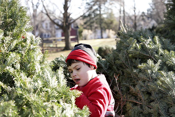 istock Young boy with autism picks out his Christmas tree 475881804