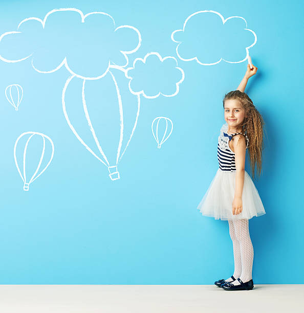 istock Cute girl making chalk drawings 475883132