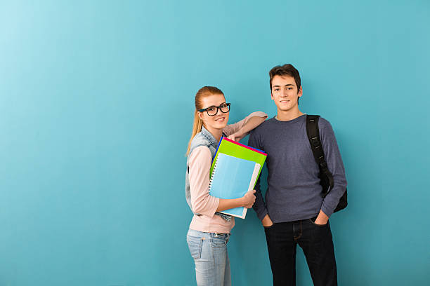 istock Two teenage students holding books 475885755
