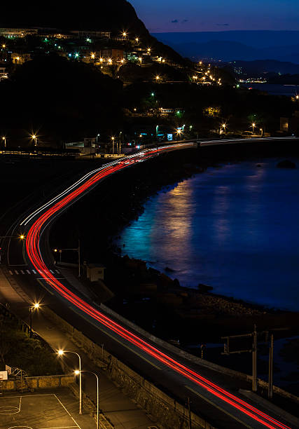 istock car tail on the road side by the sea 475886792