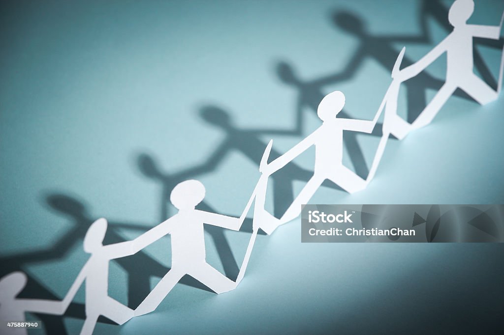 Group of people holding hands Group of people made of paper are holding hands together. Team concept. 2015 Stock Photo