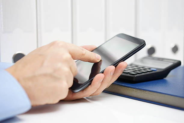 istock Businessman using mobile phone application for accounting in office 475888232