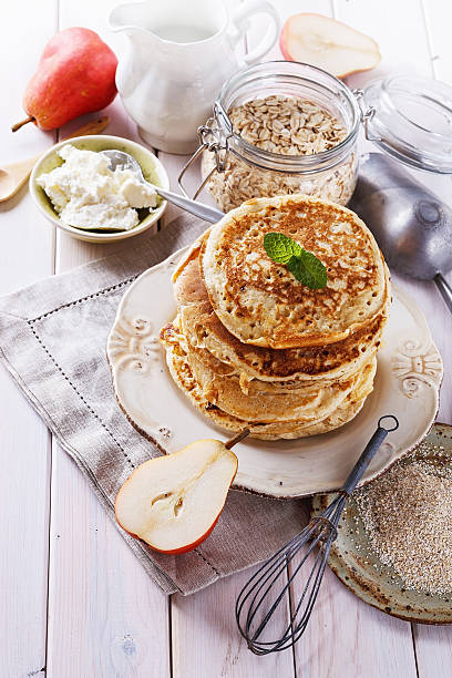 istock Healthy oat pancakes over white wooden background 475889078
