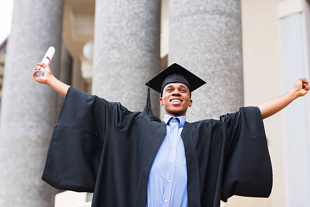 istock african male graduate holding his diploma 475890015
