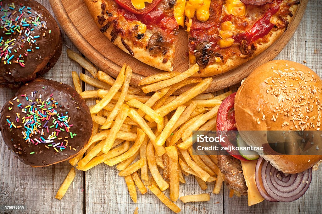 Fast food set Closeup of home made burgers , french fries and donuts on wooden background Unhealthy Eating Stock Photo