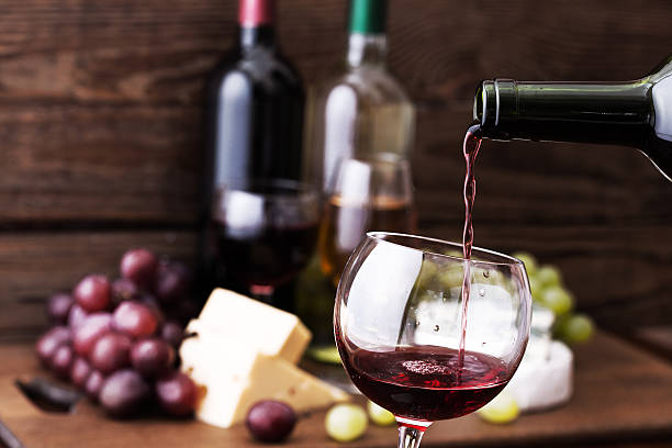 istock Red wine pouring into glass, close-up 475895684