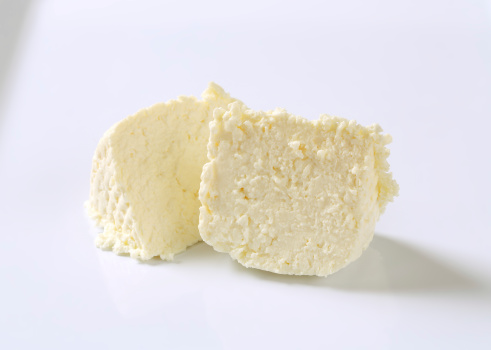 slices of fresh cheese on white background