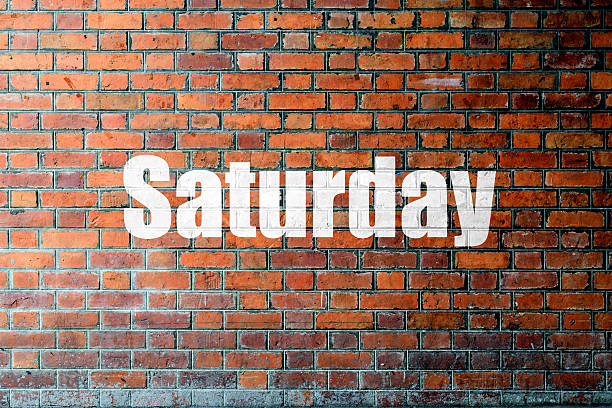 istock Red Brick wall texture with a word Saturday 475897892