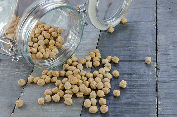 istock chikpeas tumbling out of a jar 475898018