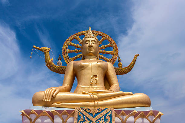 istock Golden Buddha statue with blue sky background 475898088
