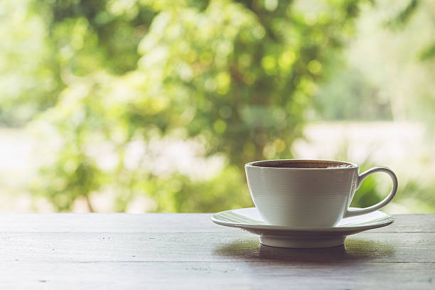 istock White coffee cup on the table at morning time 475898266