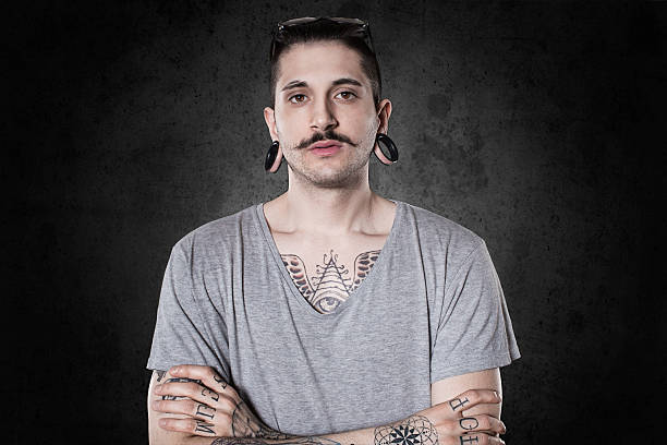istock beautiful tattooed man on wall 475898298